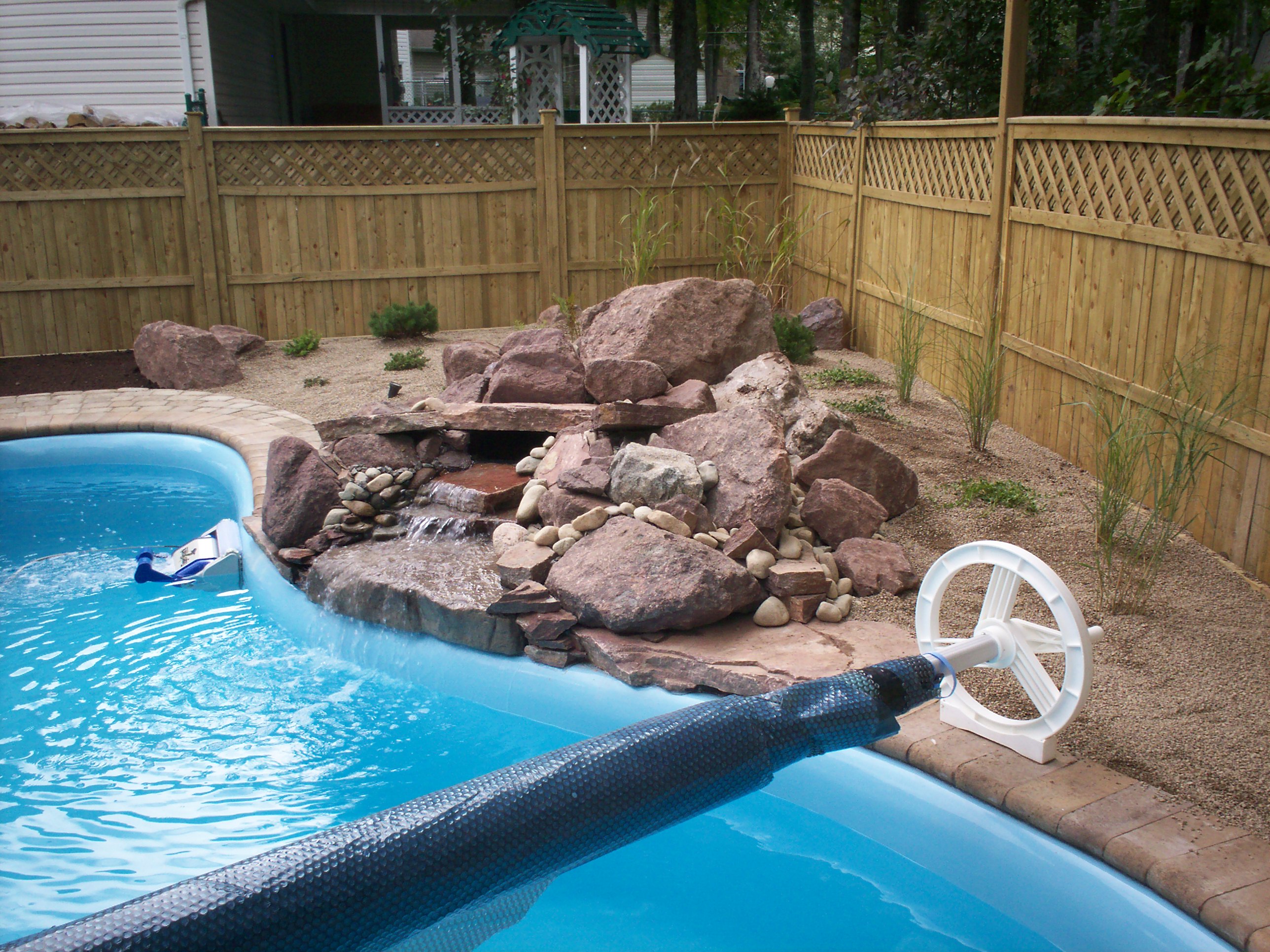 Decorative stone fountain installed in residential backyard