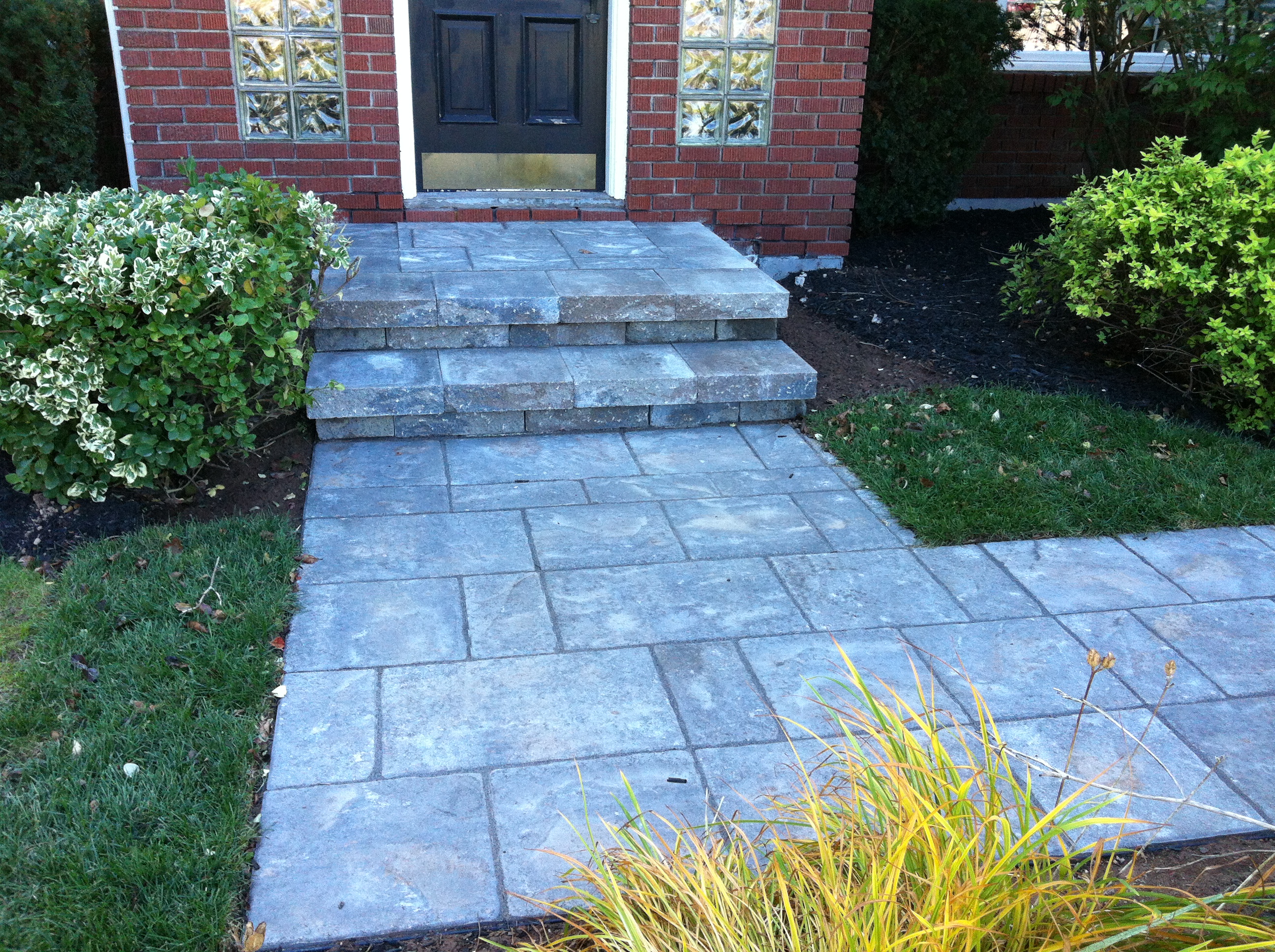 Completed stone walkway leading to front entrance
